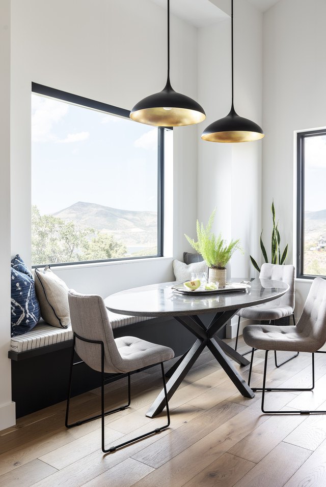 Hearth room dining room with white oak floors and black pendant lights